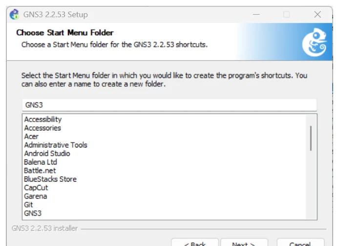 หน้าต่าง GNS3 2.2.53 Setup หัวข้อ Choose Start Menu Folder ให้เลือกโฟลเดอร์ใน Start Menu สำหรับสร้าง shortcut ช่องข้อความด้านบนกรอกคำว่า GNS3 ด้านล่างเป็นรายการโฟลเดอร์ที่มีอยู่ เช่น Accessibility, Accessories, Acer, Administrative Tools, Android Studio, Balena Ltd, Battle.net, BlueStacks Store, CapCut, Garena, Git และ GNS3 มีปุ่ม Back, Next และ Cancel