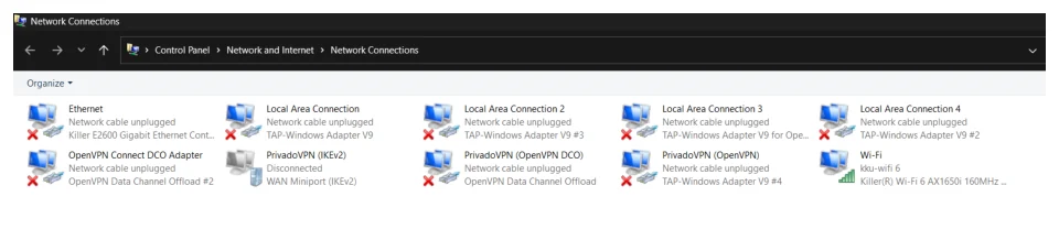 หน้าต่าง Network Connections ของ Windows ธีมมืด แถบที่อยู่เขียนว่า Control Panel ตามด้วย Network and Internet ตามด้วย Network Connections ในพื้นที่หลักมีไอคอนการ์ดเครือข่ายเรียงกันหลายอัน ได้แก่ Ethernet ที่ขึ้นว่า Network cable unplugged ใช้ชิป Killer E2600 Gigabit Ethernet, Local Area Connection ถึง Local Area Connection 4 ที่เป็น TAP-Windows Adapter V9 หลายตัว, OpenVPN Connect DCO Adapter, PrivadoVPN IKEv2 ที่ Disconnected, PrivadoVPN OpenVPN DCO, PrivadoVPN OpenVPN และ Wi-Fi ที่เชื่อมกับ kku-wifi 6 ผ่านการ์ด Killer Wi-Fi 6 AX1650i