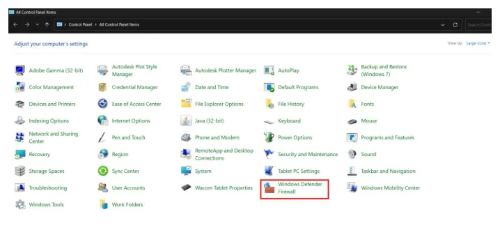 หน้าต่าง All Control Panel Items ของ Windows แบบมุมมองไอคอนใหญ่ หัวข้อเขียนว่า Adjust your computer's settings มุมขวาบนระบุ View by Large icons ในตารางไอคอนมี Adobe Gamma, AutoPlay, Backup and Restore, Color Management, Credential Manager, Date and Time, Default Programs, Device Manager, Devices and Printers, Ease of Access Center, File Explorer Options, File History, Fonts, Indexing Options, Internet Options, Java, Keyboard, Mouse, Network and Sharing Center, Pen and Touch, Phone and Modem, Power Options, Programs and Features, Recovery, Region, Security and Maintenance, Sound, Storage Spaces, Sync Center, System, Tablet PC Settings, Taskbar and Navigation, Troubleshooting, User Accounts, Wacom Tablet Properties, Windows Mobility Center, Windows Tools และ Work Folders โดยมีกรอบสีแดงล้อมไอคอน Windows Defender Firewall